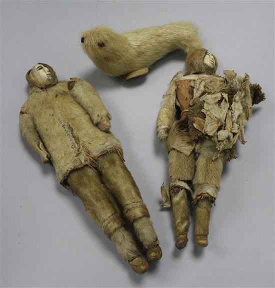 Two Inuit walrus ivory and hide figures of Eskimos, late 19th century,